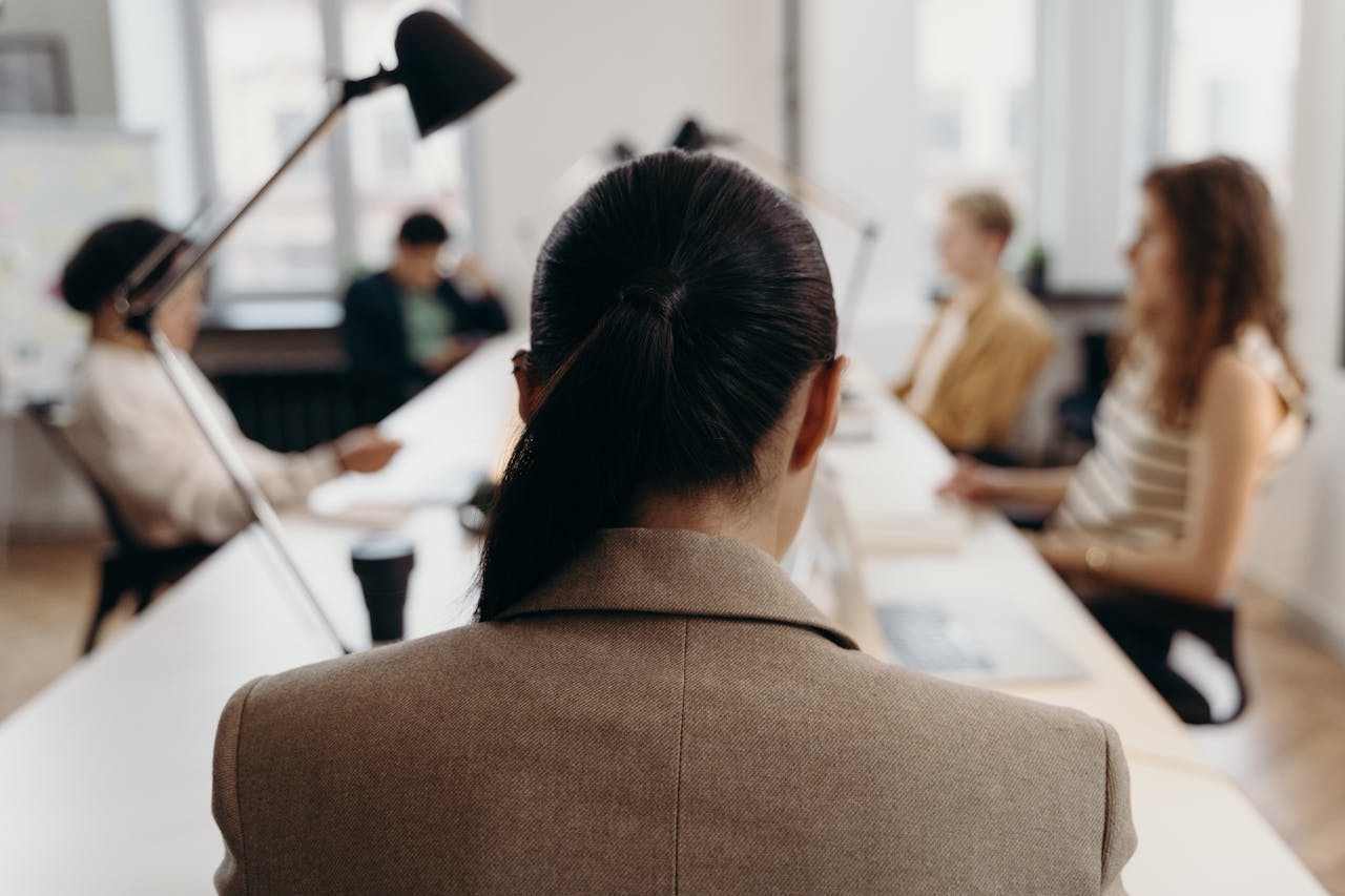 featured-portfolio-01 Diverse professionals collaborating in a modern office space, focused on teamwork and project management.